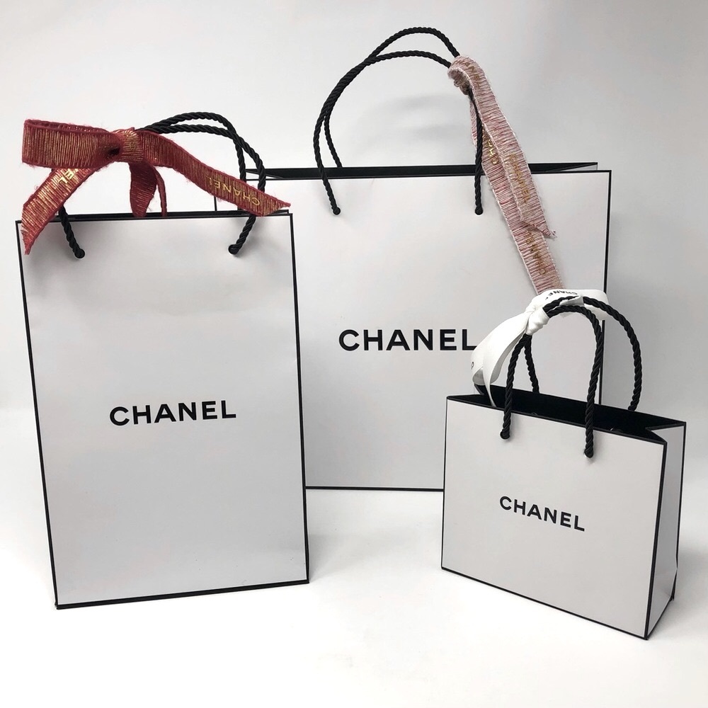 Set of three Chanel shopping / gift bags with logo ribbons on handles